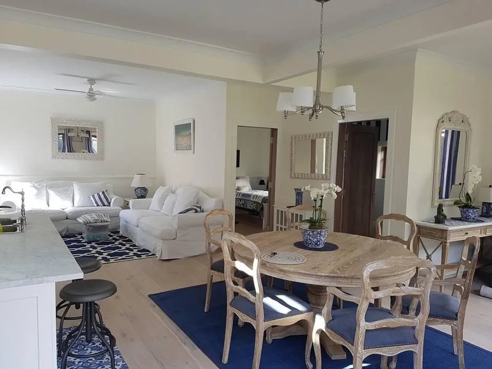 a living room filled with furniture and a dining room table
