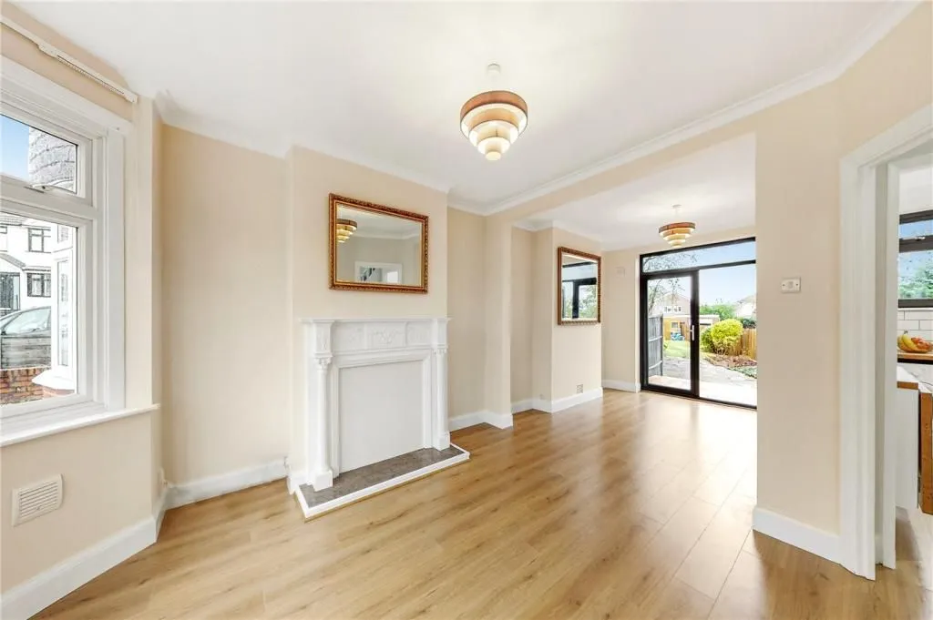 A living room with hard wood floors and a fireplace.