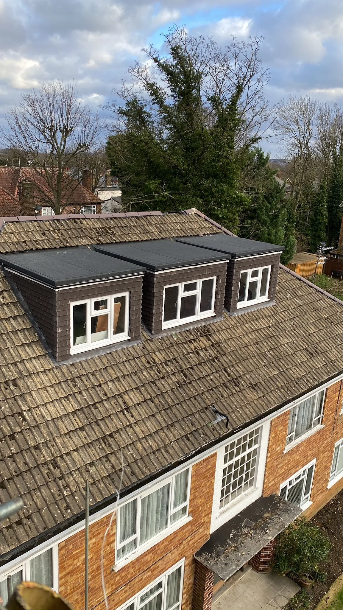 A view of a house with a tiled roof.