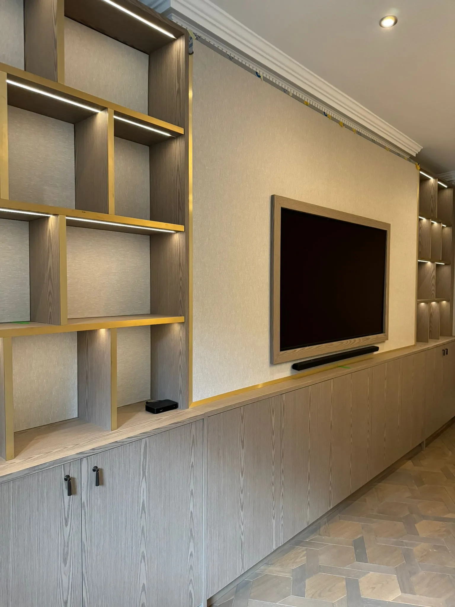 A large entertainment center with a flat screen tv.